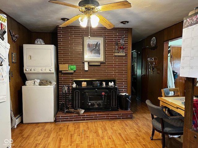 7114 Locust Lake W Dr, Spencer, IN 47460 - living area with stacked washer / drying machine, wood finished floors, a ceiling fan, and wood walls