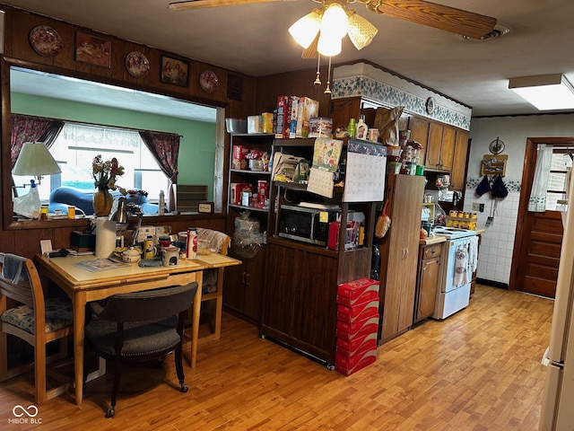 7114 Locust Lake W Dr, Spencer, IN 47460 - kitchen with white electric range oven, plenty of natural light, light wood-type flooring, and ceiling fan