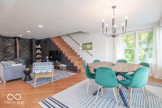 5078 Evergreen Ln, Gosport, IN 47433 - dining room with a wood stove, a chandelier, wood finished floors, stairs, and recessed lighting