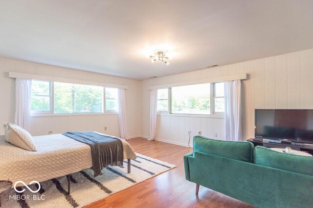 5078 Evergreen Ln, Gosport, IN 47433 - bedroom with light wood-style floors, wooden walls, and baseboards