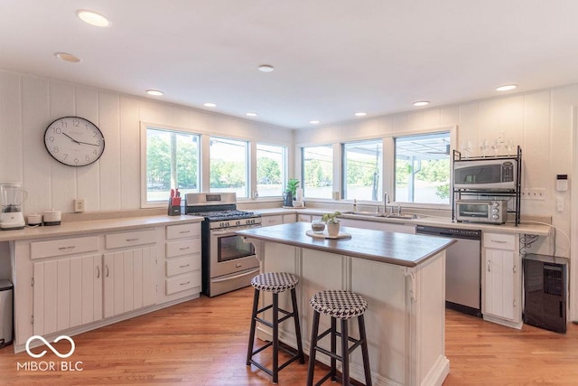 5078 Evergreen Ln, Gosport, IN 47433 - kitchen with appliances with stainless steel finishes, a sink, light wood-style flooring, white cabinets, and recessed lighting
