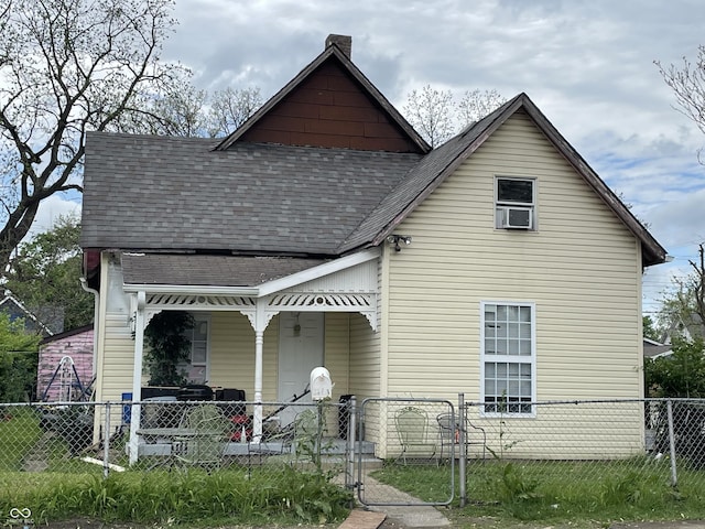 1164 Groff Ave, Indianapolis, IN 46222 - view of front facade with a porch, roof with shingles, a fenced front yard, a chimney, and a gate