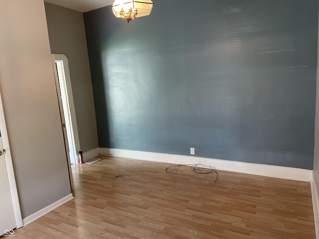 1164 Groff Ave, Indianapolis, IN 46222 - spare room with light wood-style flooring, baseboards, and arched walkways