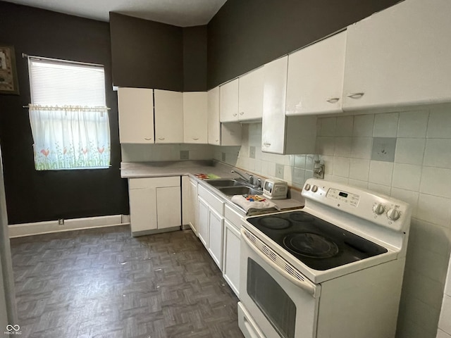 1164 Groff Ave, Indianapolis, IN 46222 - kitchen featuring white range with electric stovetop, a sink, white cabinets, light countertops, and decorative backsplash