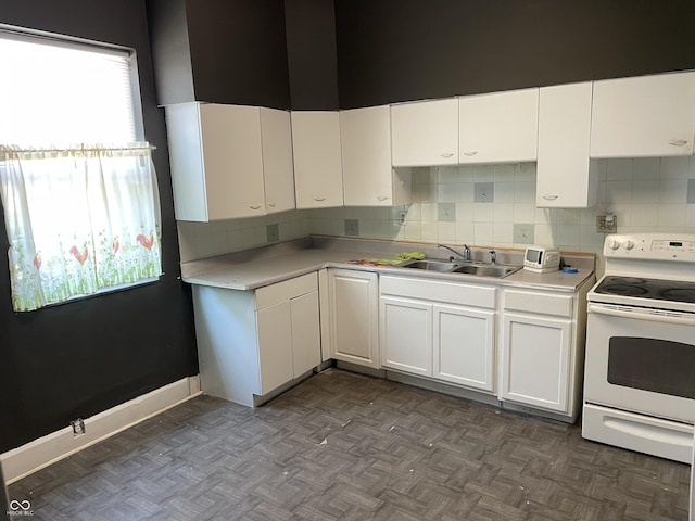 1164 Groff Ave, Indianapolis, IN 46222 - kitchen featuring electric range, a sink, and white cabinetry