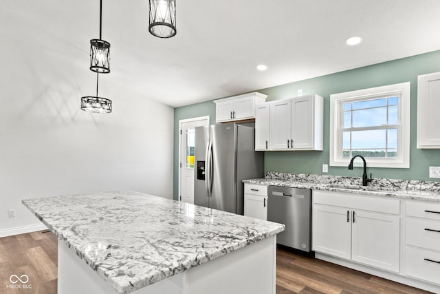 5003 W 900 N, Dupont, IN 47231 - kitchen with appliances with stainless steel finishes, a sink, dark wood finished floors, a center island, and white cabinetry