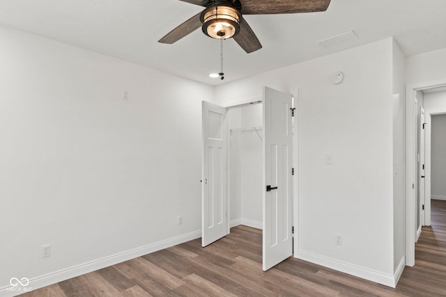 5003 W 900 N, Dupont, IN 47231 - unfurnished bedroom featuring wood finished floors, baseboards, a closet, and ceiling fan