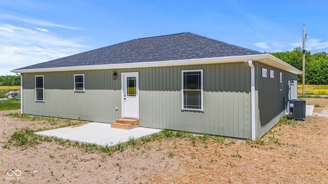 5003 W 900 N, Dupont, IN 47231 - rear view of house featuring central air condition unit, a shingled roof, and a patio area
