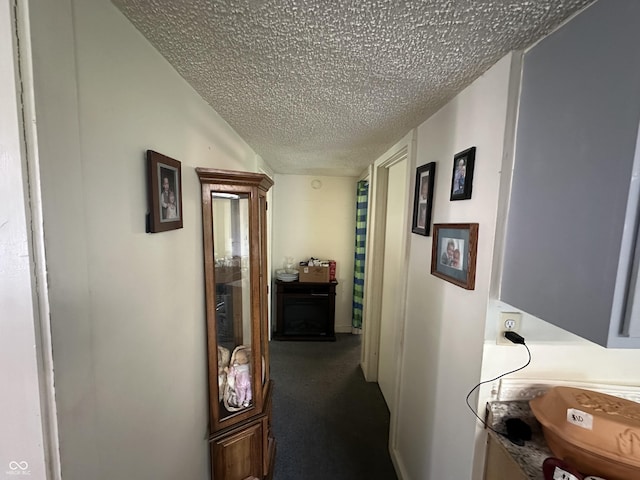 1801 E 16th St, Muncie, IN 47302 - hall featuring a textured ceiling and dark carpet
