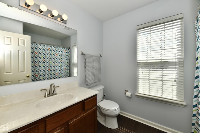 938 Weeping Way Ln, Avon, IN 46123 - full bathroom with toilet, wood finished floors, vanity, and baseboards