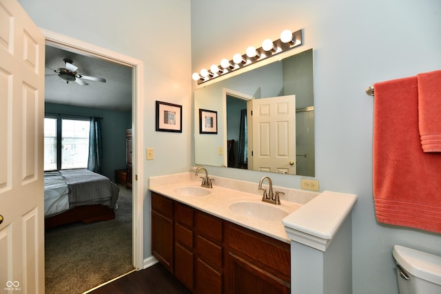 938 Weeping Way Ln, Avon, IN 46123 - ensuite bathroom featuring a ceiling fan, double vanity, toilet, and wood finished floors