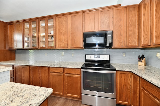938 Weeping Way Ln, Avon, IN 46123 - kitchen with stainless steel electric range, black microwave, glass insert cabinets, and tasteful backsplash