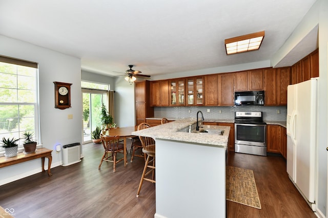 938 Weeping Way Ln, Avon, IN 46123 - kitchen with stainless steel electric range oven, white fridge with ice dispenser, black microwave, brown cabinetry, and a sink