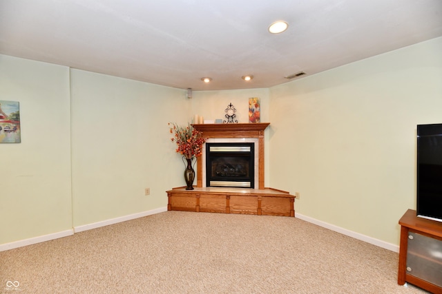 938 Weeping Way Ln, Avon, IN 46123 - unfurnished living room with carpet flooring, a glass covered fireplace, recessed lighting, and baseboards