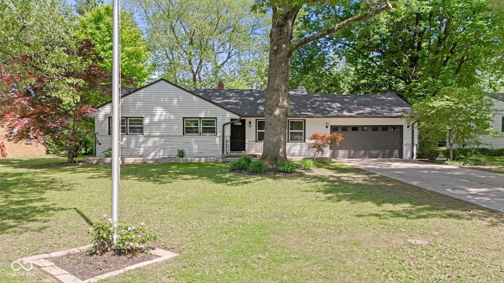5843 N Oakland Ave, Indianapolis, IN 46220 - ranch-style home with an attached garage, concrete driveway, and a front lawn