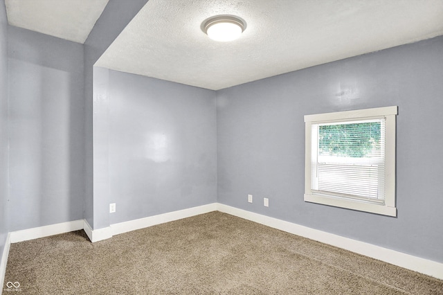 3109 E St Joseph St, Indianapolis, IN 46201 - carpeted spare room featuring baseboards and a textured ceiling