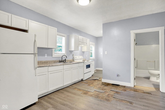 3109 E St Joseph St, Indianapolis, IN 46201 - kitchen featuring white appliances, a sink, light wood-style floors, under cabinet range hood, and white cabinetry