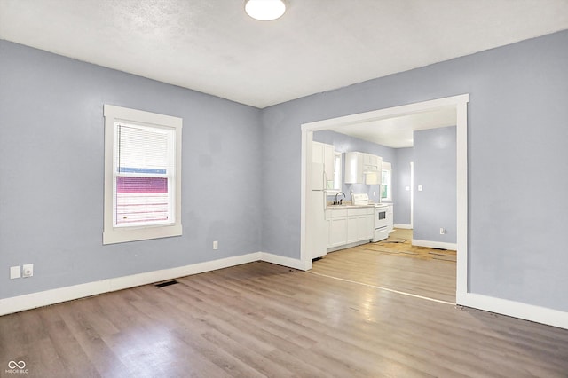 3109 E St Joseph St, Indianapolis, IN 46201 - unfurnished room with baseboards and light wood-style floors