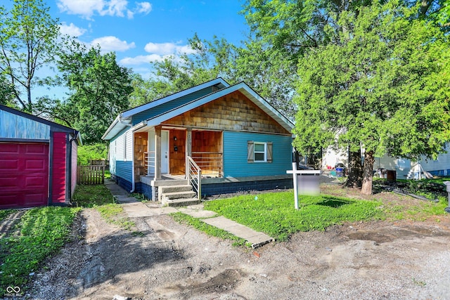 3109 E St Joseph St, Indianapolis, IN 46201 - view of front of house featuring covered porch and a garage