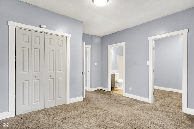3109 E St Joseph St, Indianapolis, IN 46201 - unfurnished bedroom featuring a closet, carpet, baseboards, and ensuite bath