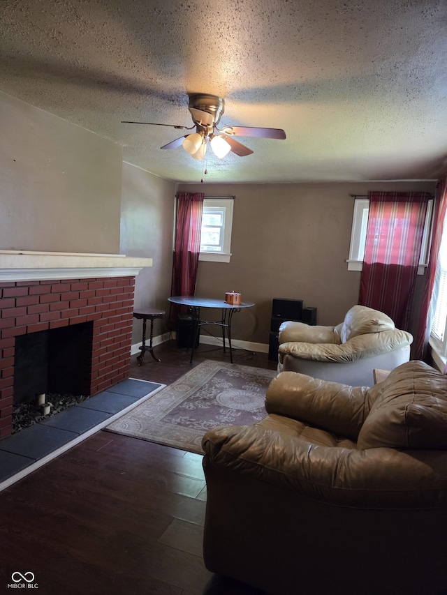 1168 N Gladstone Ave, Indianapolis, IN 46201 - living room with a textured ceiling, ceiling fan, a fireplace, wood finished floors, and baseboards
