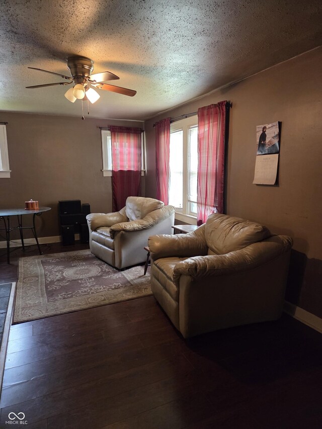 1168 N Gladstone Ave, Indianapolis, IN 46201 - living room featuring a textured ceiling, baseboards, ceiling fan, and wood finished floors