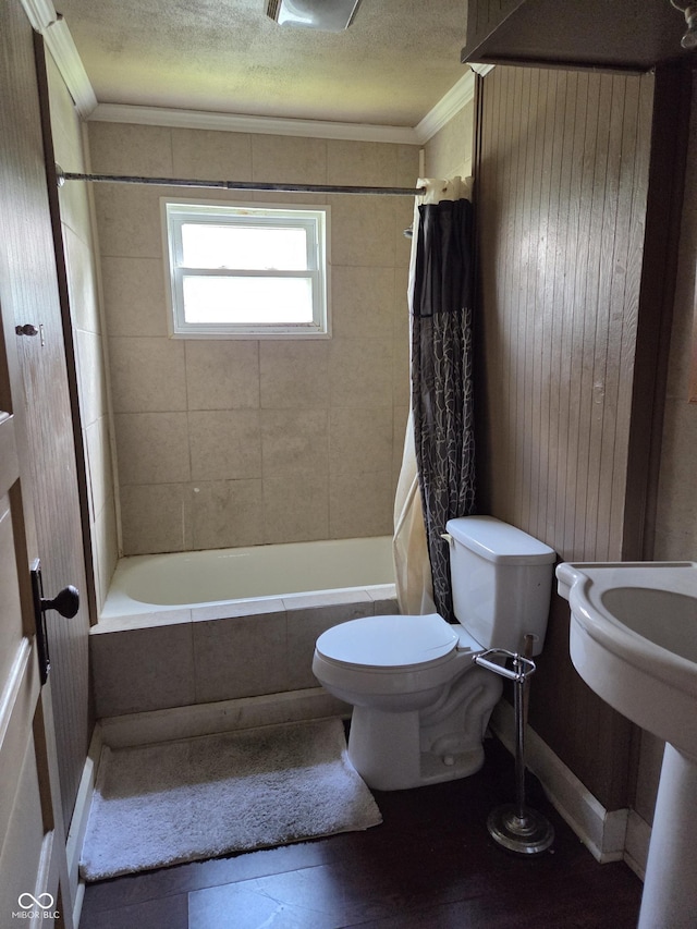 1168 N Gladstone Ave, Indianapolis, IN 46201 - bathroom with ornamental molding, toilet, tiled shower / bath combo, and a textured ceiling