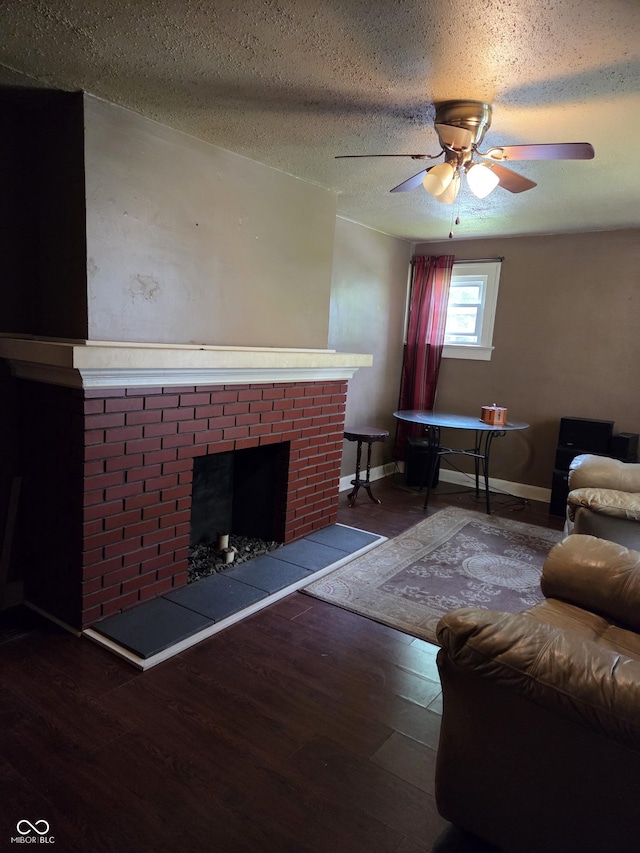 1168 N Gladstone Ave, Indianapolis, IN 46201 - living area with a brick fireplace, wood finished floors, baseboards, ceiling fan, and a textured ceiling
