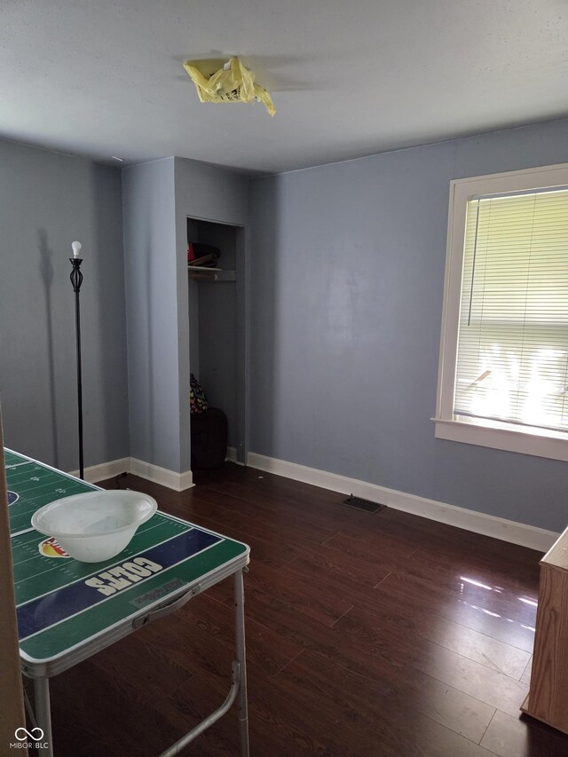 1168 N Gladstone Ave, Indianapolis, IN 46201 - bedroom with wood finished floors, baseboards, and a closet