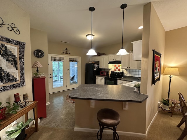 5486 Lipizzan Ln, Plainfield, IN 46168 - kitchen with black appliances, dark countertops, white cabinets, a peninsula, and a breakfast bar area