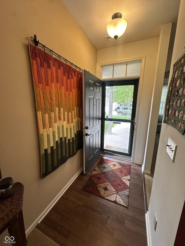 5486 Lipizzan Ln, Plainfield, IN 46168 - entrance foyer featuring baseboards, wood finished floors, and a textured ceiling