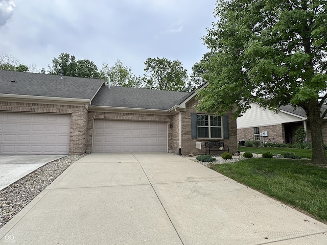 5486 Lipizzan Ln, Plainfield, IN 46168 - view of front of property with brick siding, concrete driveway, an attached garage, and a front lawn