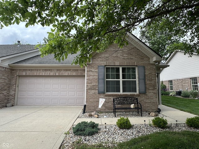5486 Lipizzan Ln, Plainfield, IN 46168 - ranch-style home with brick siding, concrete driveway, an attached garage, and central AC unit
