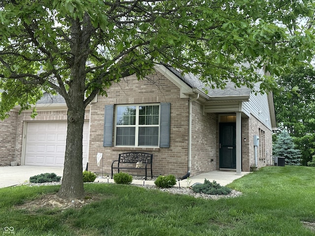 5486 Lipizzan Ln, Plainfield, IN 46168 - view of front of property with brick siding, a front lawn, central AC, driveway, and a garage