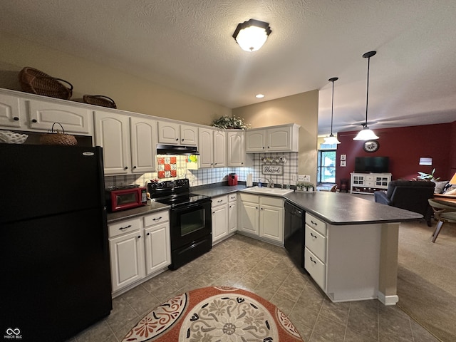 5486 Lipizzan Ln, Plainfield, IN 46168 - kitchen featuring black appliances, a peninsula, a sink, dark countertops, and a textured ceiling