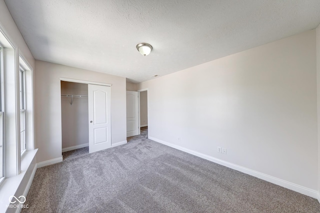 4055 Steelewater Way, Indianapolis, IN 46235 - unfurnished bedroom with carpet floors, baseboards, a textured ceiling, and a closet