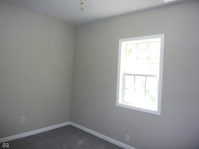 2007 Park Ave, Anderson, IN 46016 - empty room with dark colored carpet and baseboards