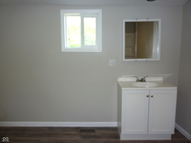 2007 Park Ave, Anderson, IN 46016 - bathroom featuring vanity, baseboards, and wood finished floors