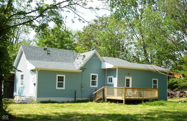 2007 Park Ave, Anderson, IN 46016 - rear view of property featuring a wooden deck, a lawn, and roof with shingles