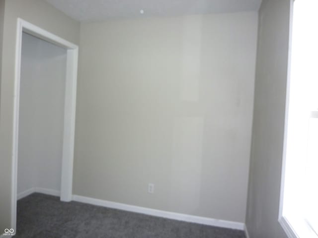 2007 Park Ave, Anderson, IN 46016 - empty room with dark carpet and baseboards