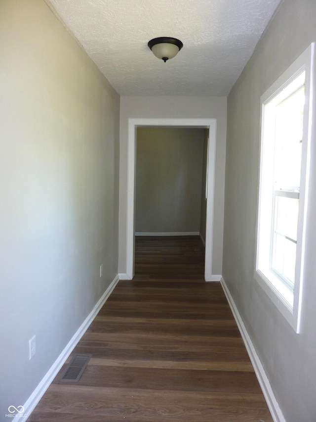 2007 Park Ave, Anderson, IN 46016 - corridor with a textured ceiling, baseboards, and dark wood-style floors