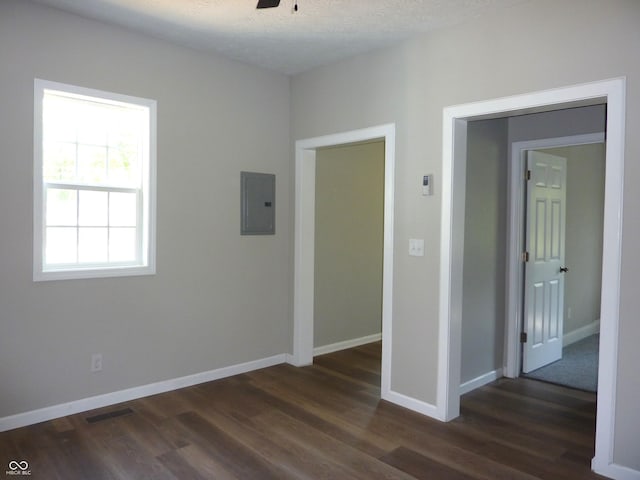 2007 Park Ave, Anderson, IN 46016 - unfurnished bedroom featuring dark wood-style flooring, electric panel, and baseboards