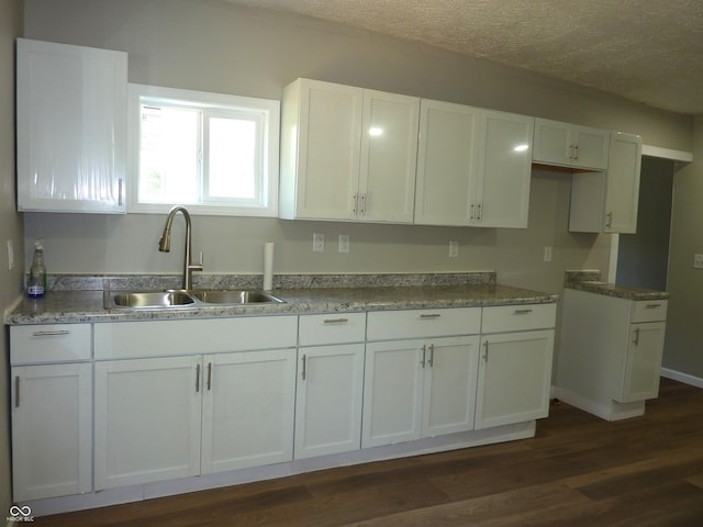 2007 Park Ave, Anderson, IN 46016 - kitchen with a sink, white cabinets, dark wood-style flooring, and a textured ceiling