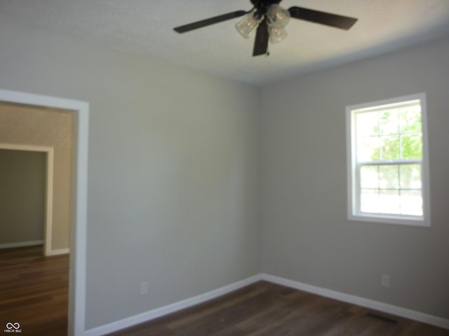 2007 Park Ave, Anderson, IN 46016 - unfurnished room featuring dark wood-style floors, a ceiling fan, and baseboards