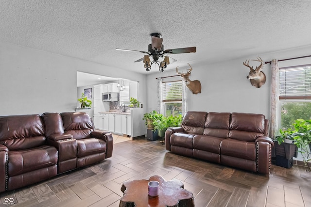 805 Sunvista Dr, Avon, IN 46123 - living room featuring a ceiling fan, plenty of natural light, and a textured ceiling