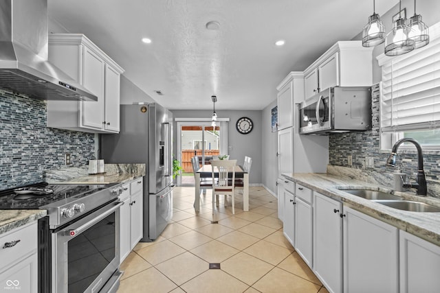 805 Sunvista Dr, Avon, IN 46123 - kitchen with premium appliances, wall chimney exhaust hood, a sink, white cabinets, and tasteful backsplash