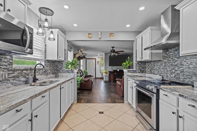805 Sunvista Dr, Avon, IN 46123 - kitchen featuring appliances with stainless steel finishes, wall chimney exhaust hood, a sink, ceiling fan, and white cabinetry