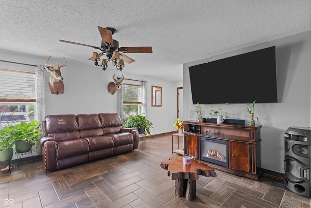 805 Sunvista Dr, Avon, IN 46123 - living area featuring a ceiling fan, baseboards, and a textured ceiling
