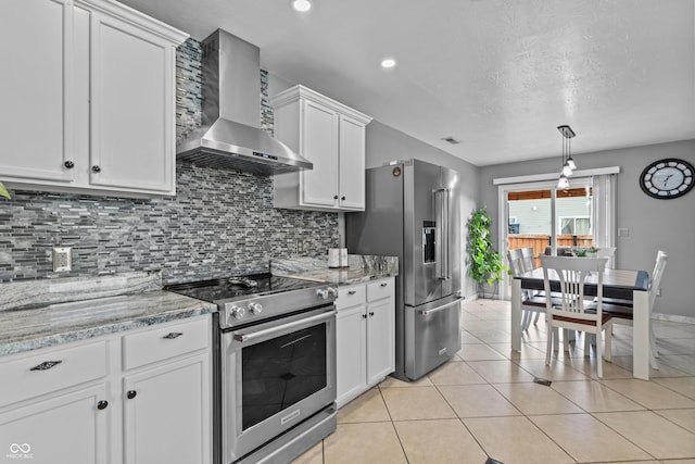 805 Sunvista Dr, Avon, IN 46123 - kitchen featuring stainless steel appliances, wall chimney exhaust hood, decorative backsplash, white cabinets, and baseboards