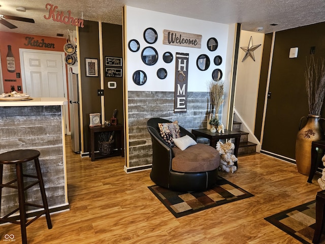 4962 Potomac Square Pl, Indianapolis, IN 46268 - living area featuring a textured ceiling, wood finished floors, a ceiling fan, stairs, and baseboards